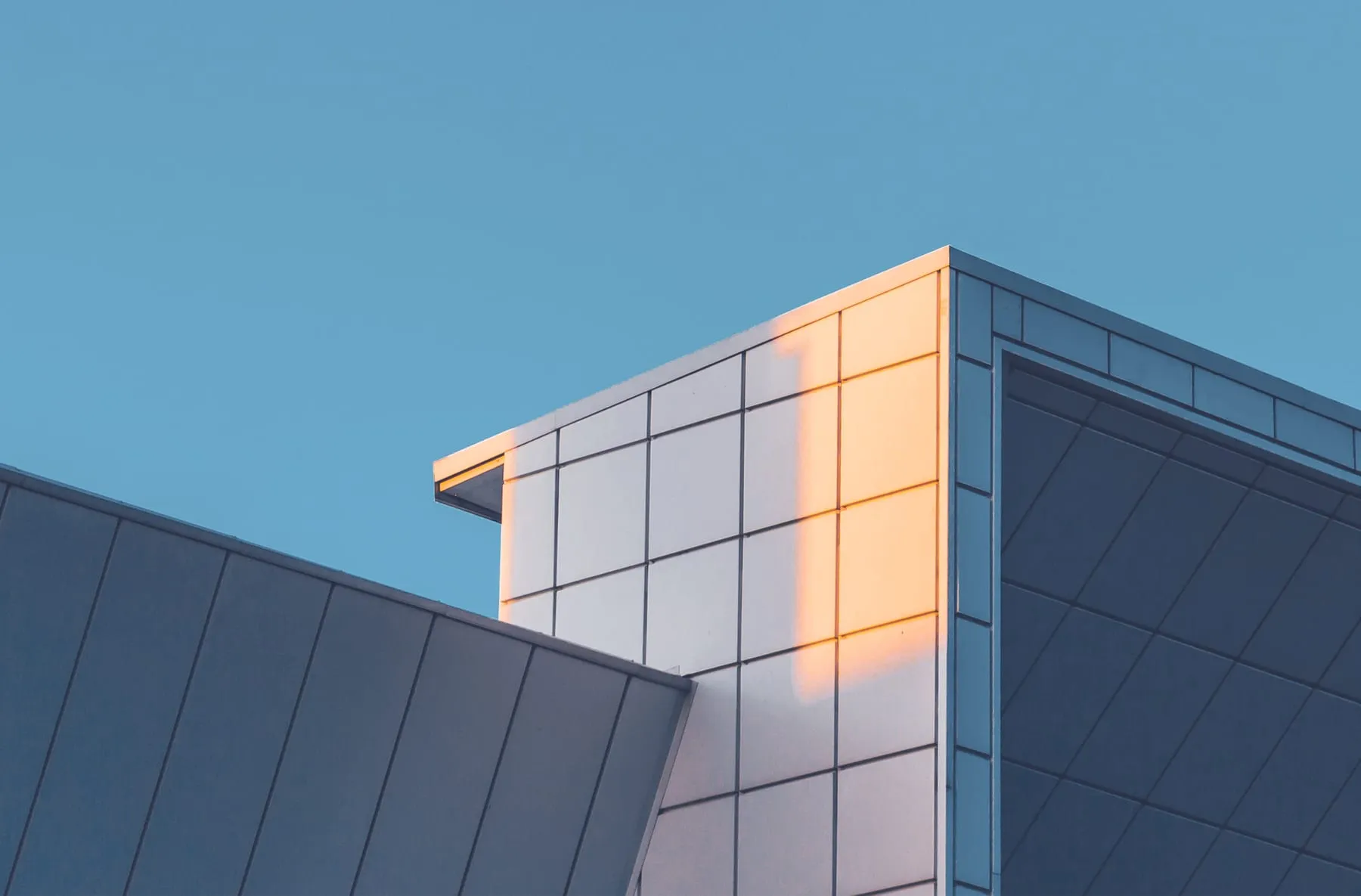 Modern commercial building with spotless glass at golden hour